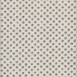 Detail of fabric in a painterly dot print in blue and brown on a cream field.