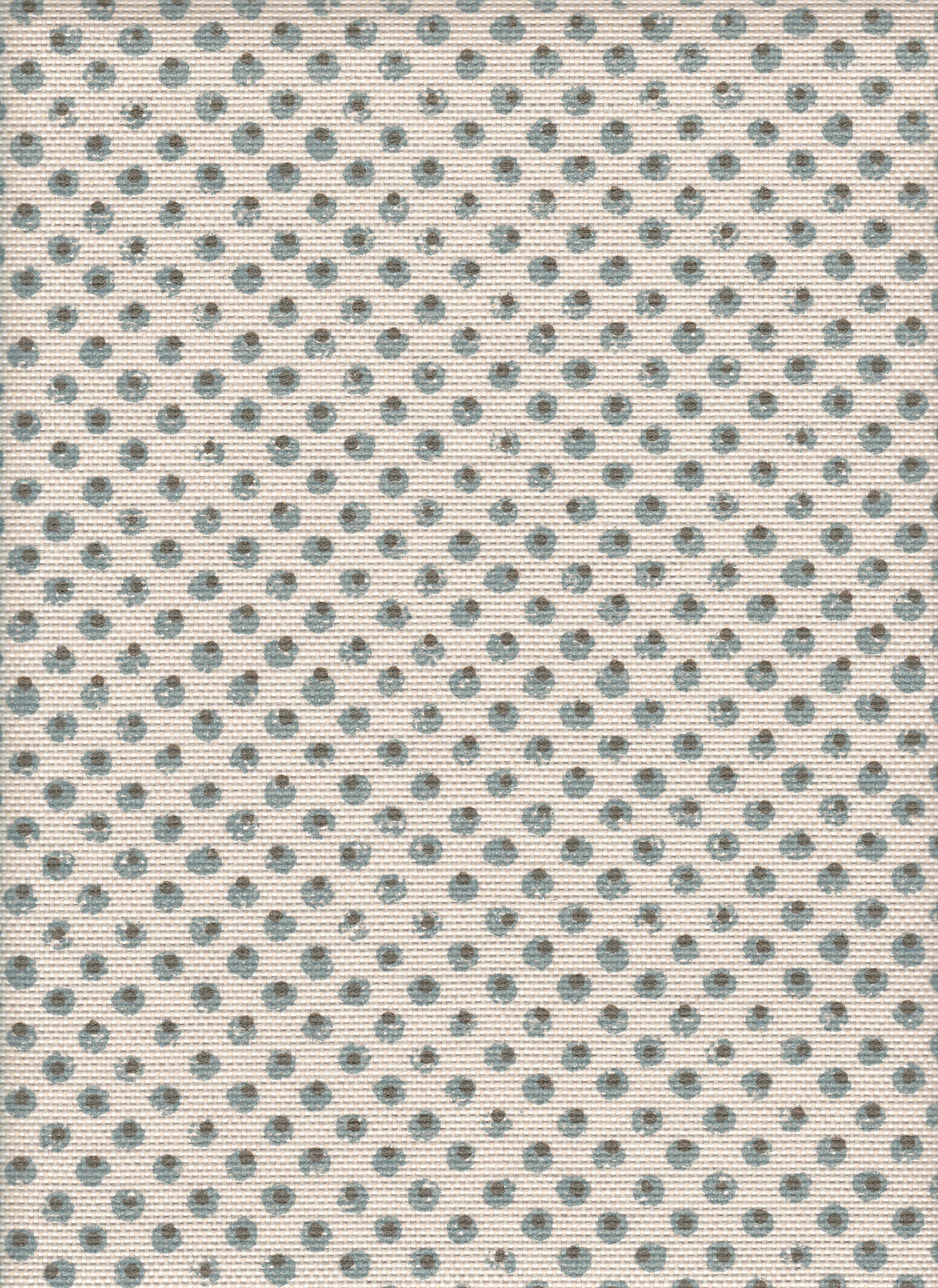 Detail of fabric in a painterly dot print in blue and brown on a cream field.