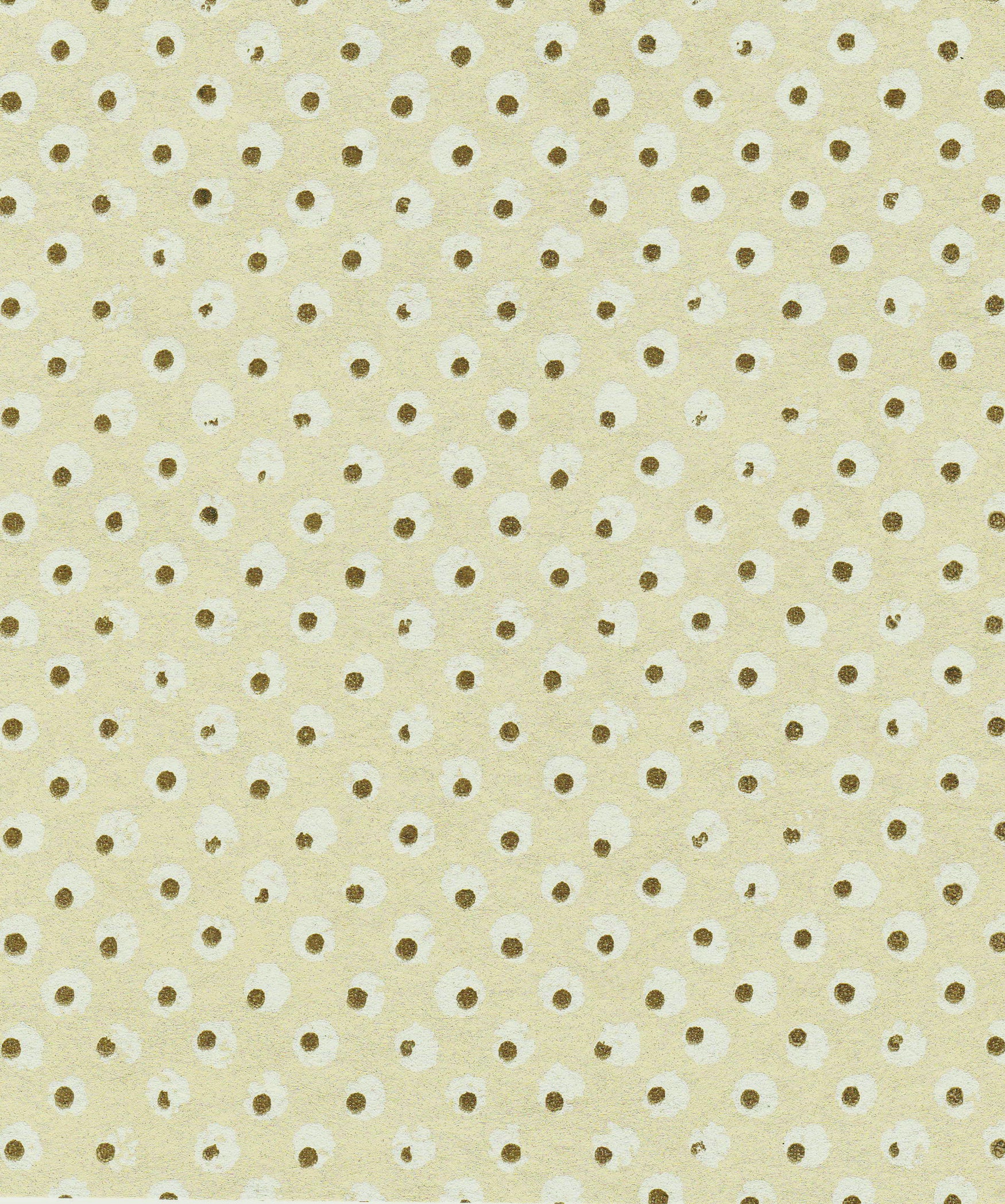 Detail of wallpaper in a painterly dot print in white and brown on a yellow field.