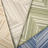 Broadloom carpet in zig zag pattern in tan, grey, green and blue. 