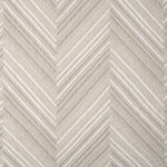 Broadloom carpet with a graphic herringbone pattern in shades of taupe. 