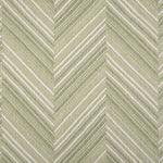Broadloom carpet with a graphic herringbone pattern in shades of pastel green and white. 