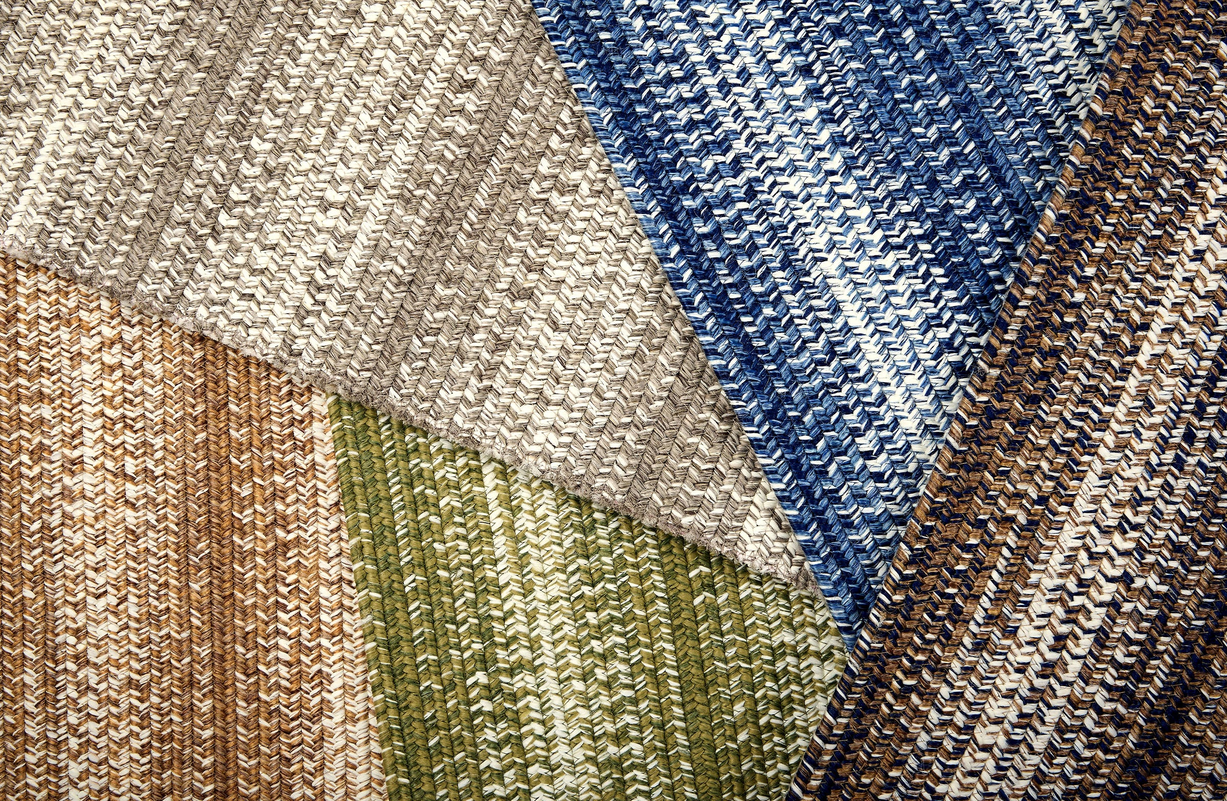 Broadloom carpet swatches in textural braid pattern in various colors. 