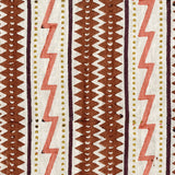Fabric in a playful stripe and zigzag pattern in shades of brown, coral and yellow on a cream field.