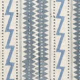 Fabric in a playful stripe and zigzag pattern in shades of gray and blue on a cream field.