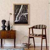 A midcentury inspired living room with a wall papered in a painterly abstract print in white on a cream field.