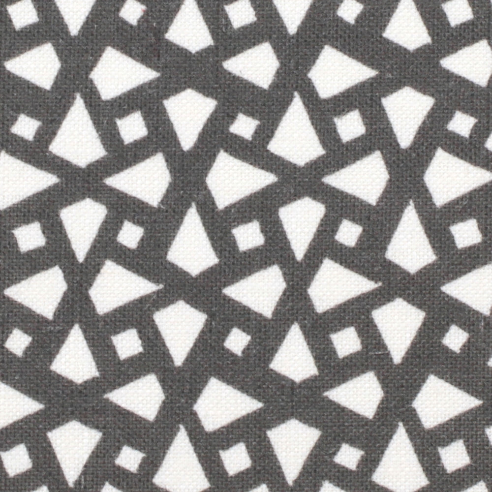 Detail of fabric in a geometric lattice print in charcoal on a white field.