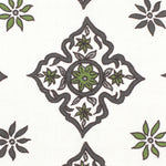 Detail of fabric in a diamond damask print in shades of green and gray on a white field.