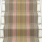 Striped flatweave runner in pink and sage on white staircase