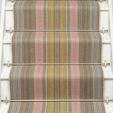 Striped flatweave runner in pink and sage on white staircase