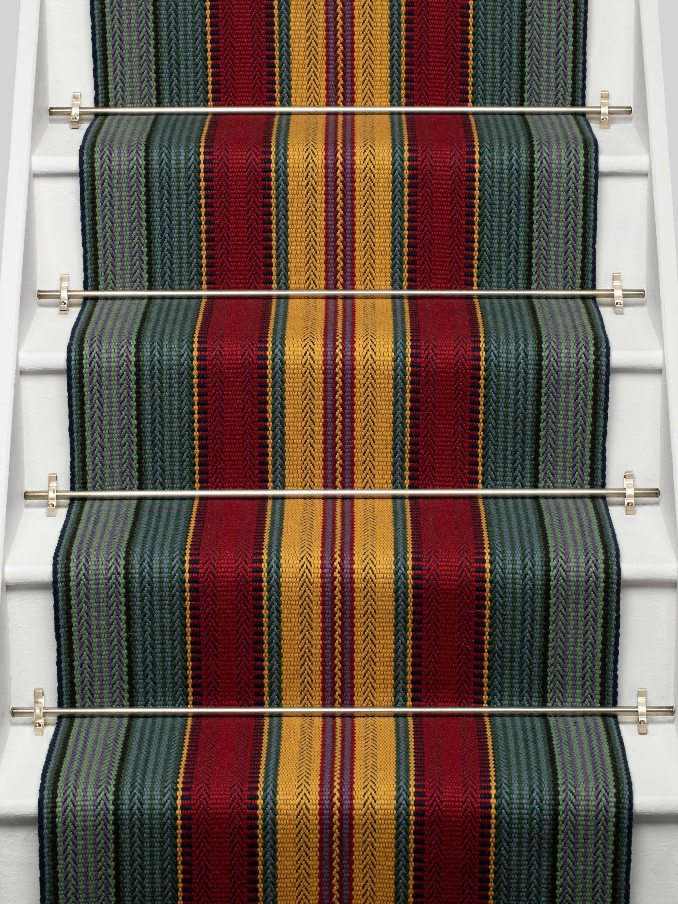 Striped flatweave runner in red yellow green and blue on white staircase