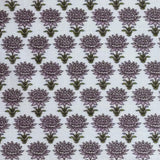 Pattern of purple flowers with green stems on a light blue background