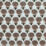 Patterned fabric with orange and green floral design on a light background