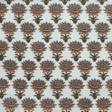 Patterned fabric with orange and green floral design on a light background