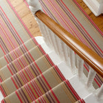 Striped flatweave runner in blue orange green and red on white staircase