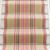 Striped flatweave runner in sage yellow and pink on white staircase