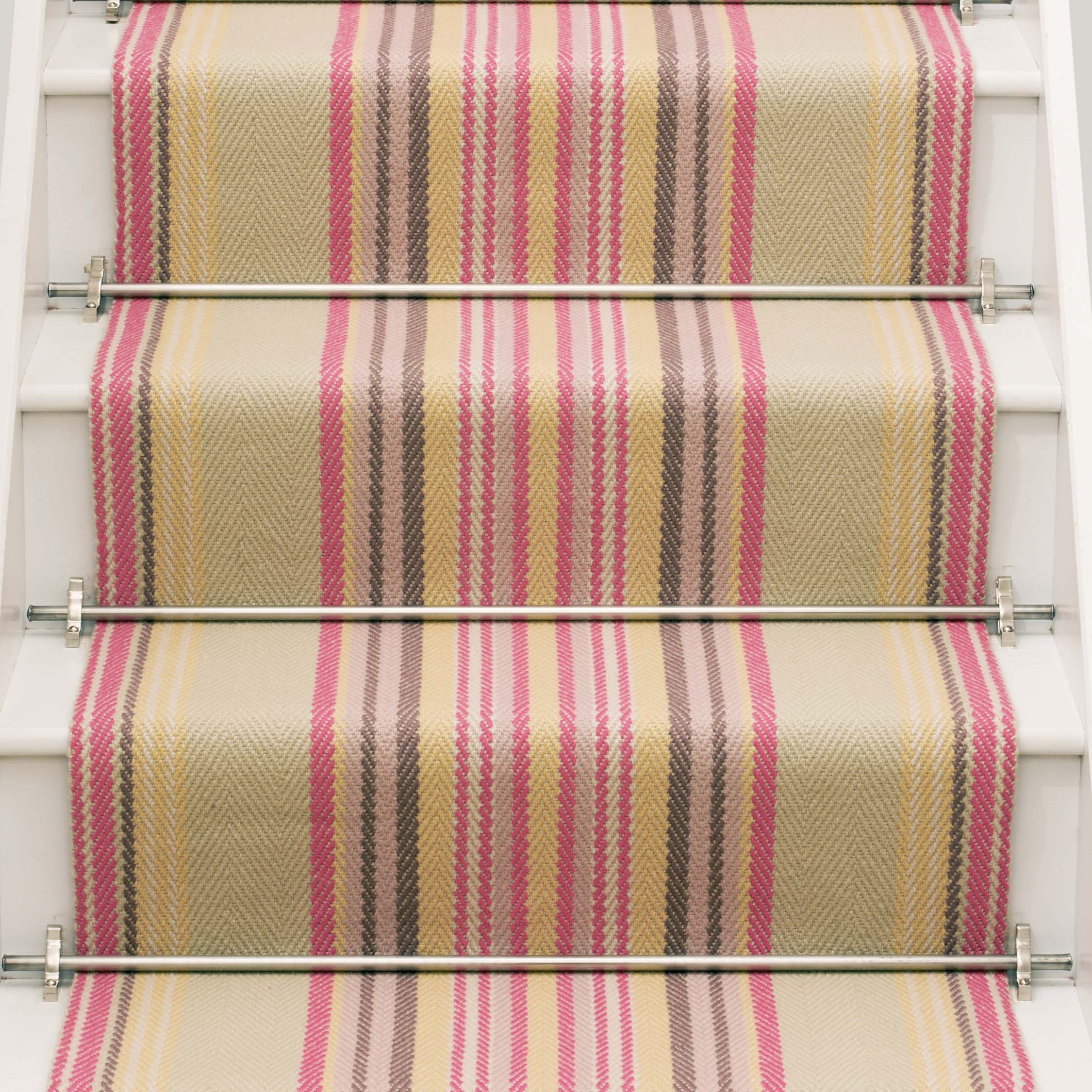 Striped flatweave runner in sage yellow and pink on white staircase