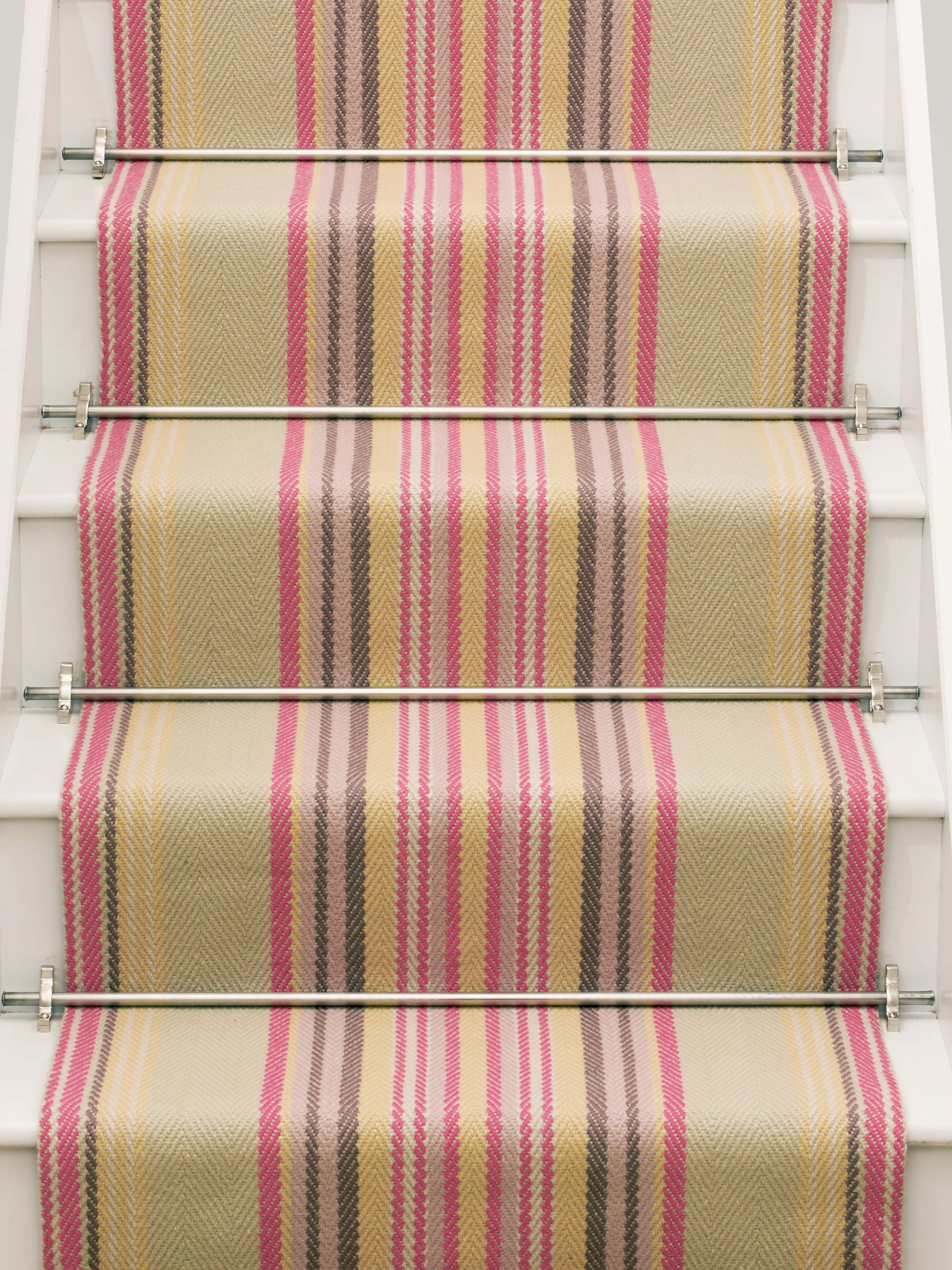 Striped flatweave runner in sage yellow and pink on white staircase