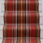 Striped flatweave runner in red yellow white and black on white staircase