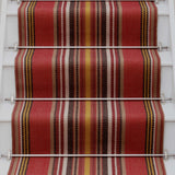 Striped flatweave runner in red yellow white and black on white staircase