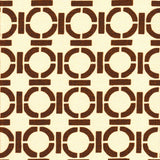 Detail of fabric in a round geometric grid print in brown on a cream field.