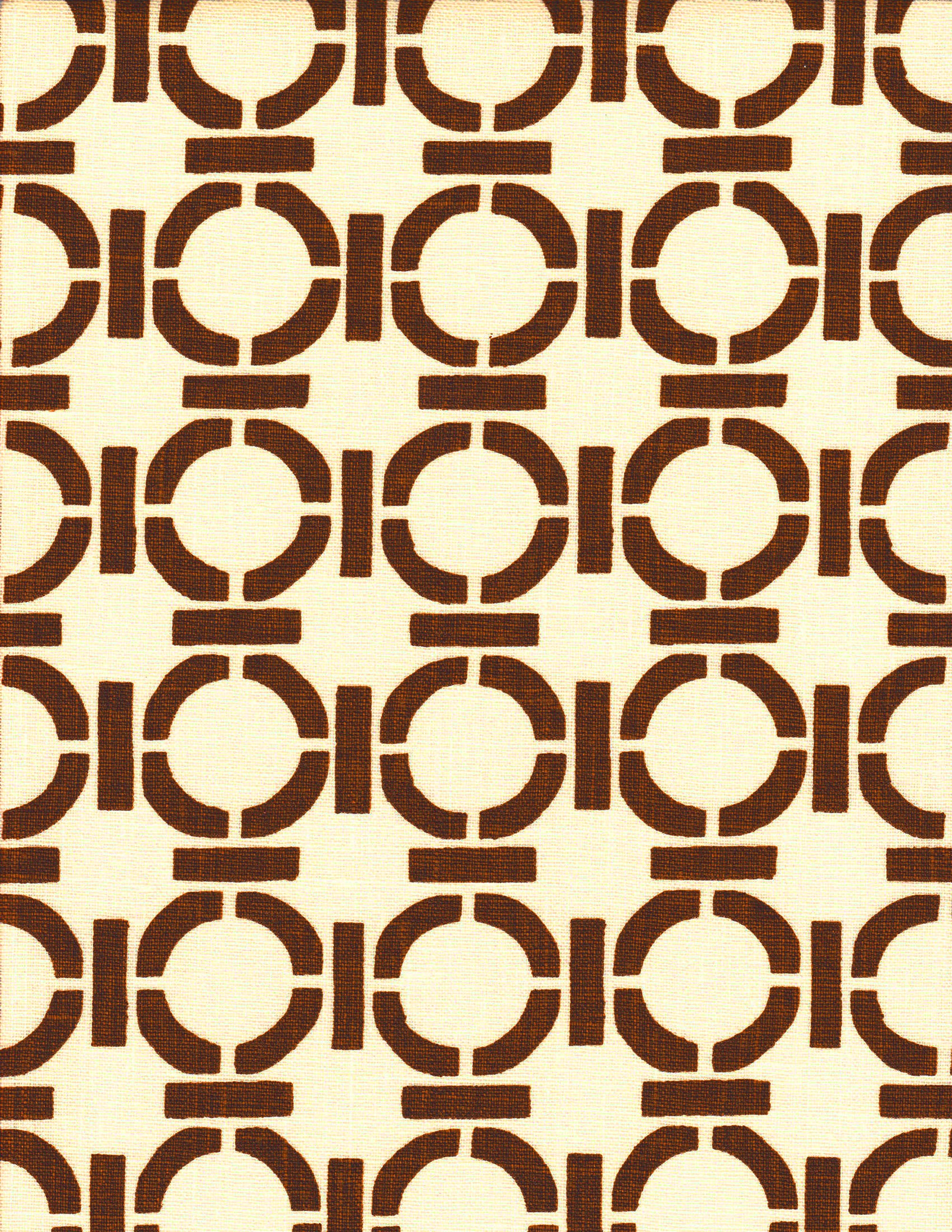 Detail of fabric in a round geometric grid print in brown on a cream field.