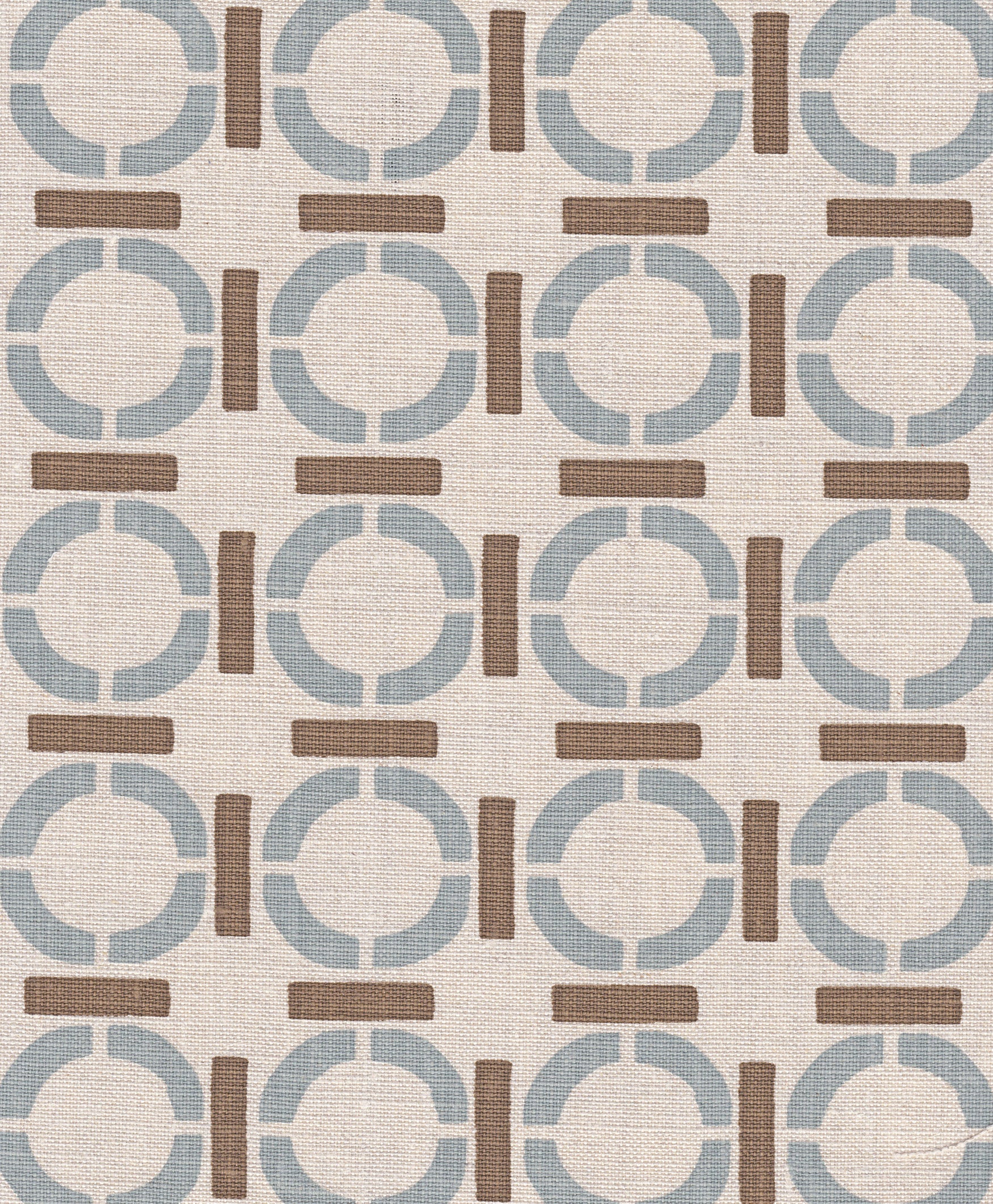 Detail of fabric in a round geometric grid print in light brown and blue on a tan field.