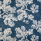 Detail of wallpaper in a playful botanical print in blue and white on a navy field.