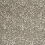 Detail of a printed linen fabric in a repeating chrysanthemum pattern in cream on a light brown field.