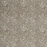 Detail of a printed linen fabric in a repeating chrysanthemum pattern in cream on a light brown field.