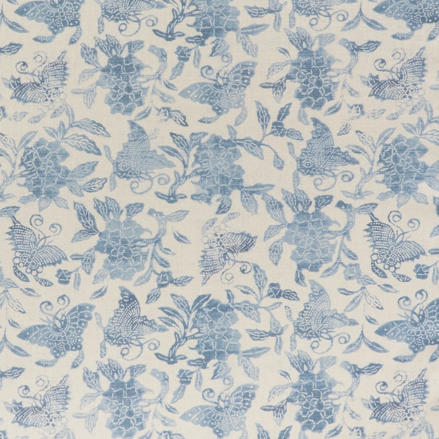 Printed linen fabric in a repeating flower and butterfly pattern in misty blue on a cream field.