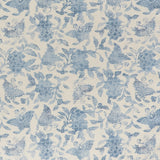 Printed linen fabric in a repeating flower and butterfly pattern in misty blue on a cream field.