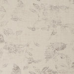 Detail of a printed linen fabric in a repeating flower and butterfly pattern in misty brown on a cream field.