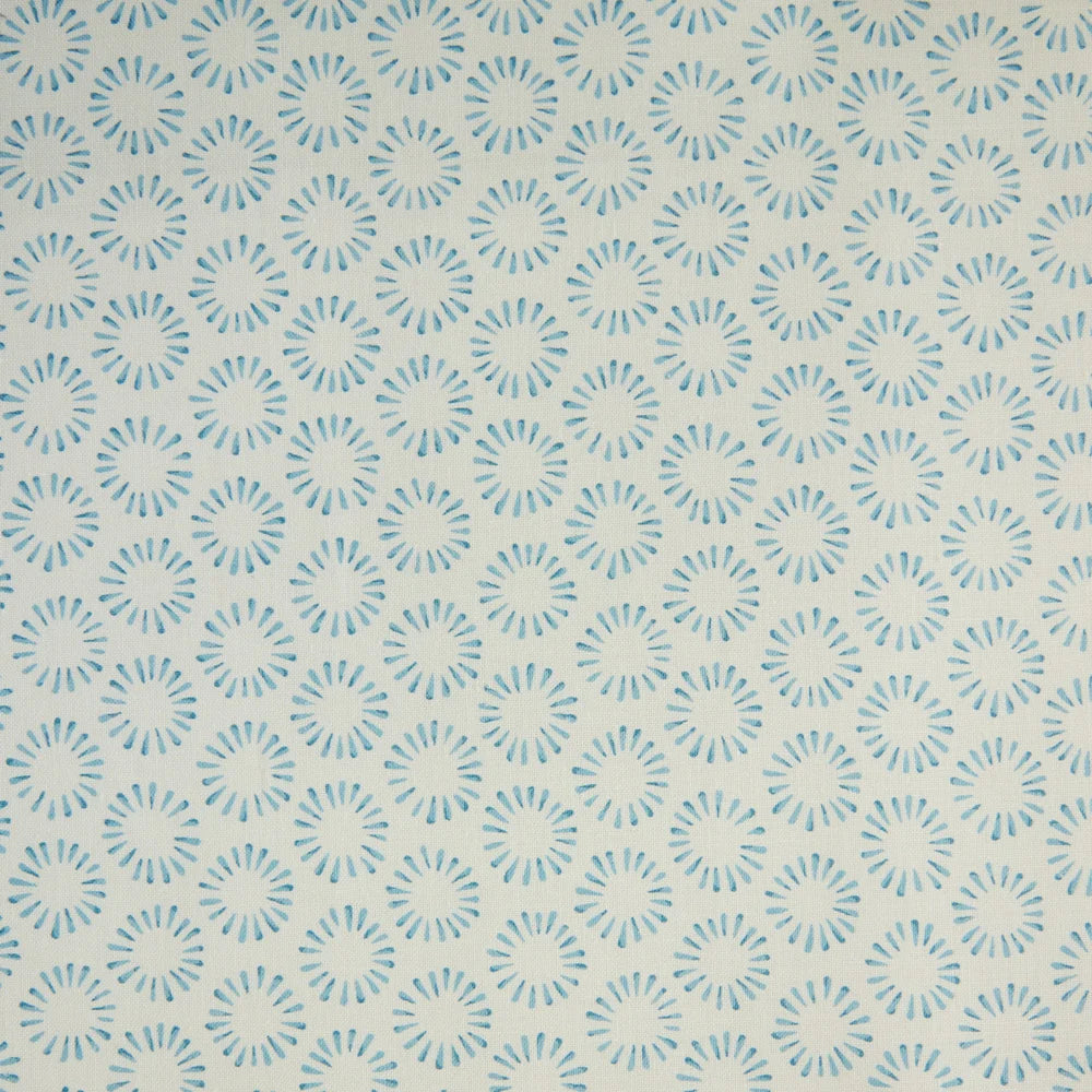 Detail of fabric in a playful circular print in blue on a greige field.