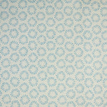 Detail of fabric in a playful circular print in blue on a greige field.