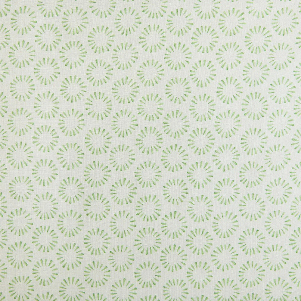 Detail of fabric in a playful circular print in green on a greige field.