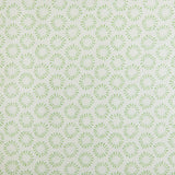 Detail of fabric in a playful circular print in green on a greige field.