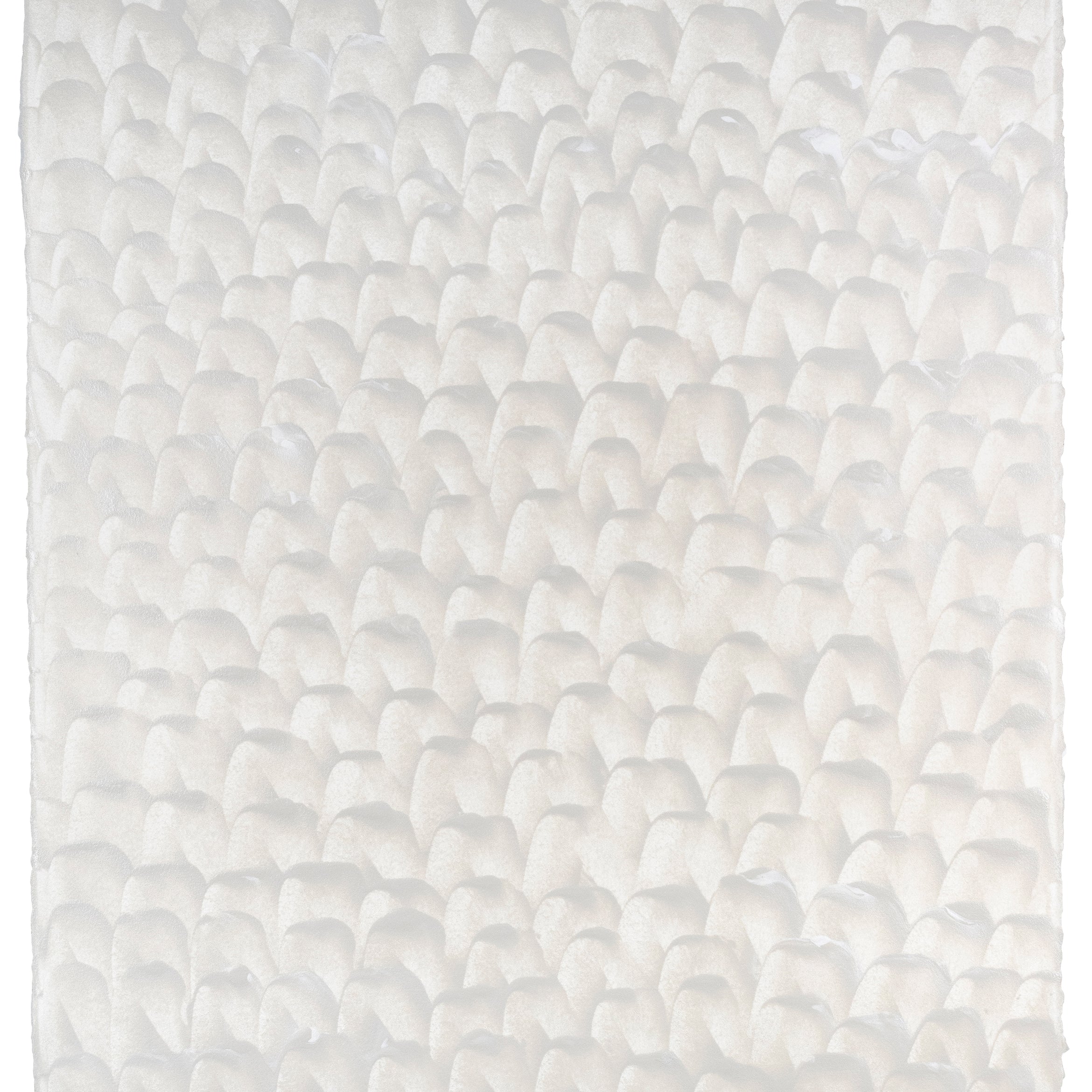Sheet of hand-painted wallpaper with a repeating dappled texture in cream.