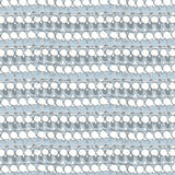 Detail of fabric in a dense curvilinear stripe print in cream, blue and gray.