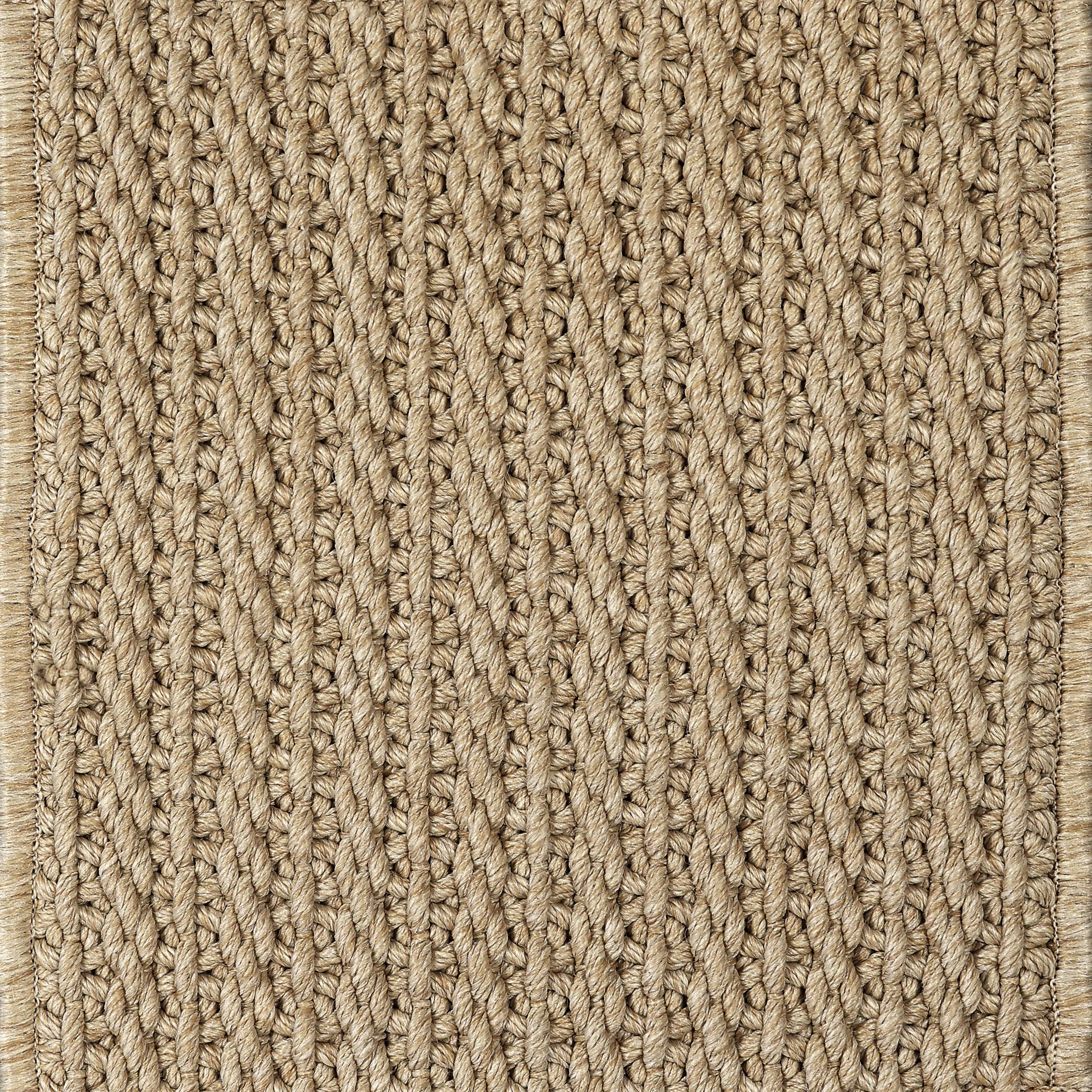 Close-up of a textured beige woven carpet