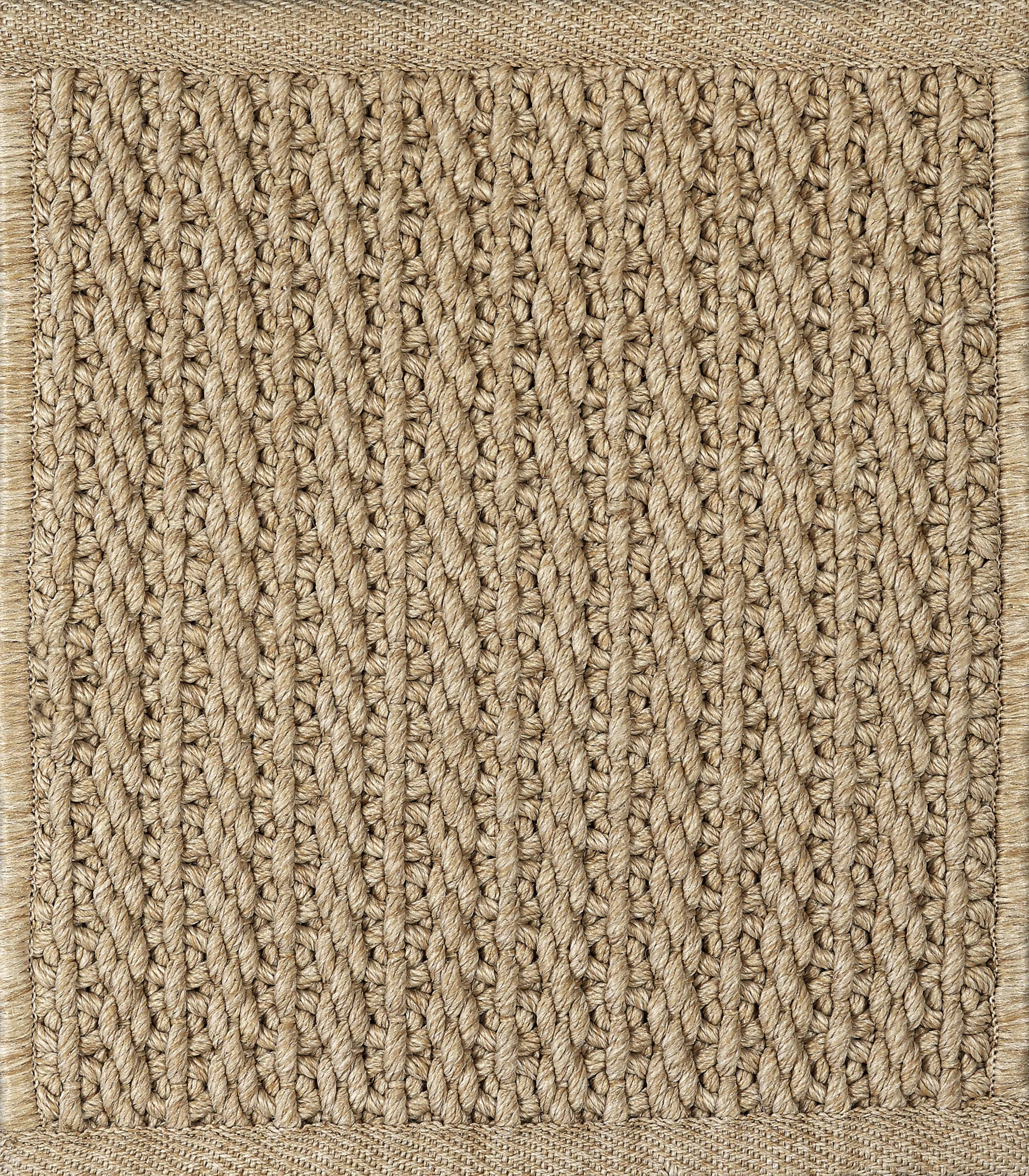 Close-up of a textured beige woven carpet
