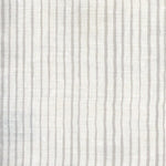 Fabric in a painterly stripe pattern in gray on a white field.