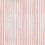 Fabric in a painterly stripe pattern in coral on a white field.