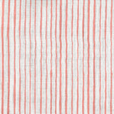 Fabric in a painterly stripe pattern in coral on a white field.