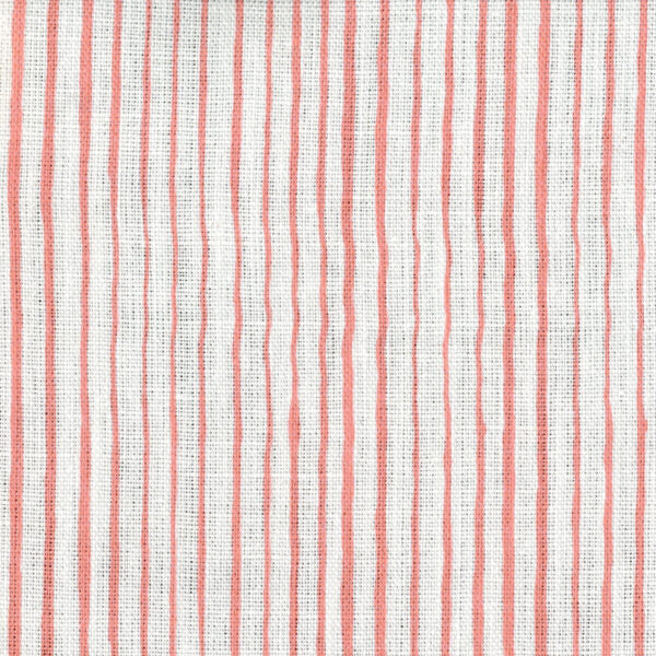 Fabric in a painterly stripe pattern in coral on a white field.