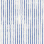 Fabric in a painterly stripe pattern in blue on a white field.