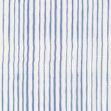 Fabric in a painterly stripe pattern in blue on a white field.