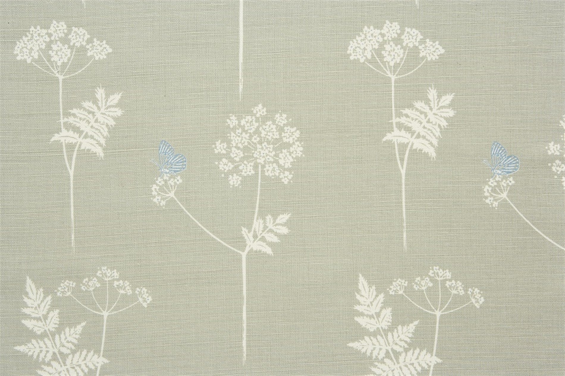 Detail of fabric in a playful flower and butterfly print in cream and blue on a greige field.