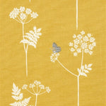 Detail of fabric in a playful flower and butterfly print in white and charcoal on a mustard field.