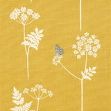 Detail of fabric in a playful flower and butterfly print in white and charcoal on a mustard field.